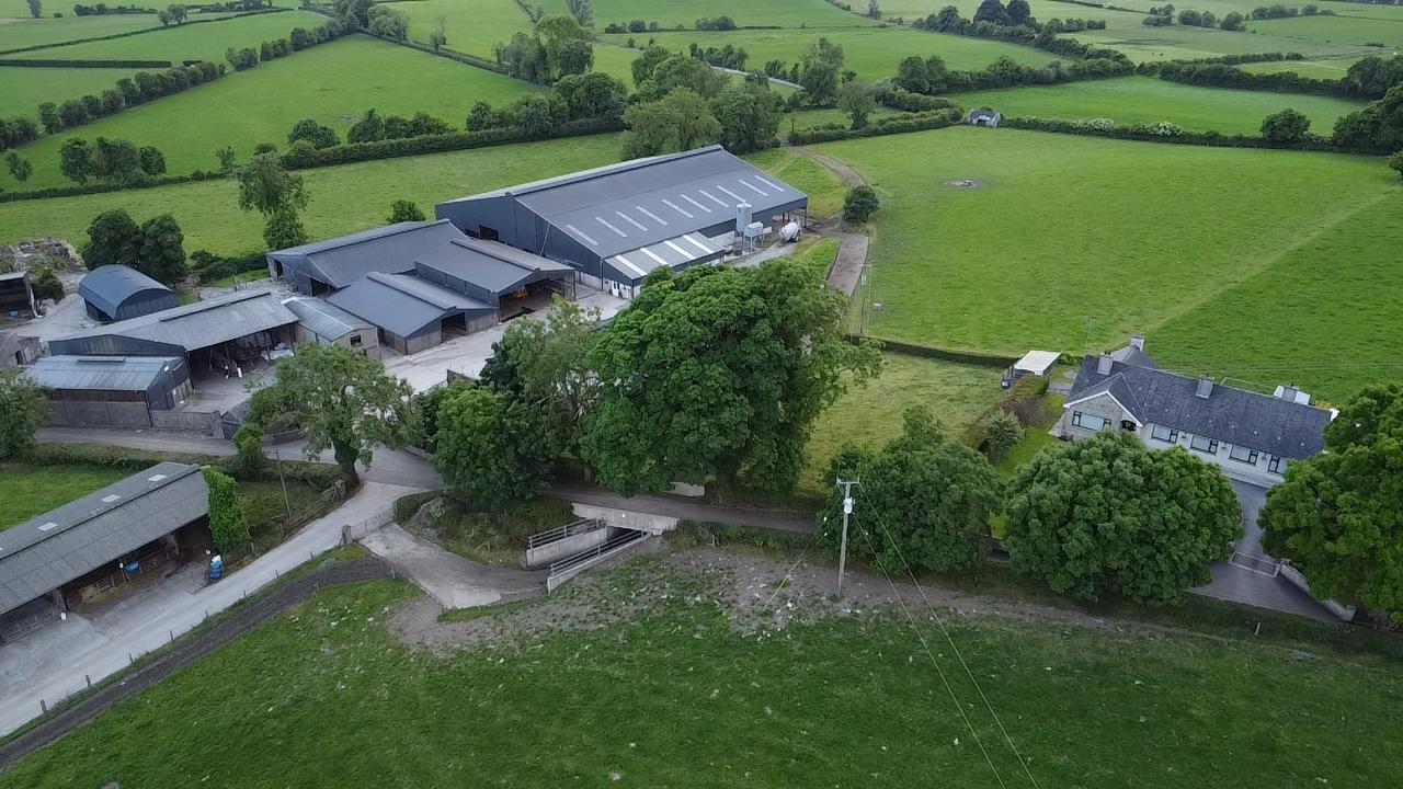 Aerial drone view of Tully farm buildings, surrounding green fields and farmhouse