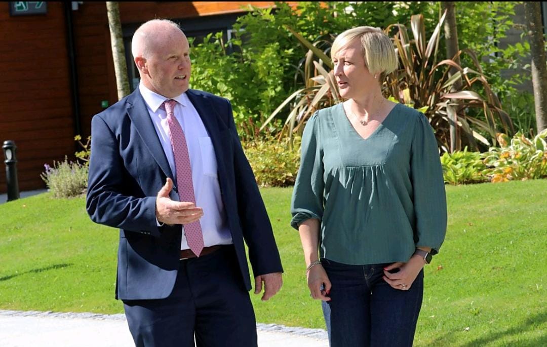 Niall Matthews in conversation outdoors, discussing dairy industry matters