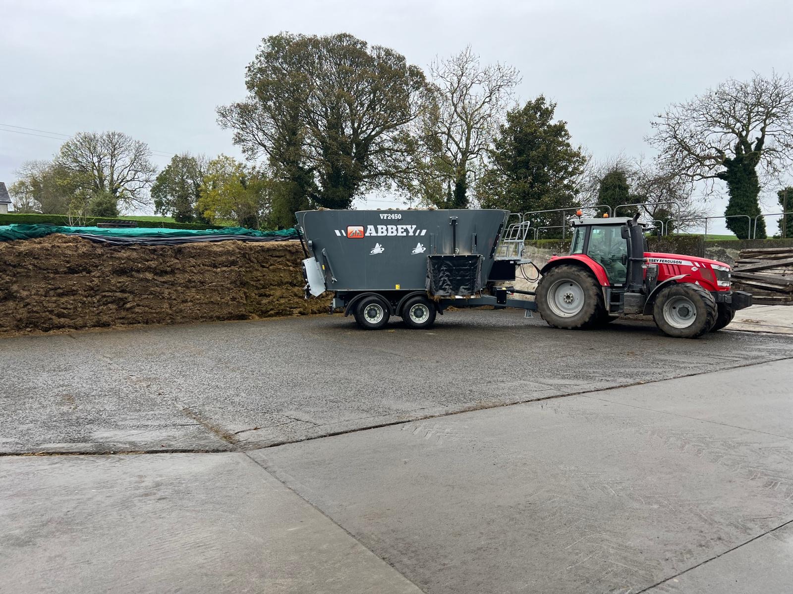 Tractor and diet feeder in the farmyard